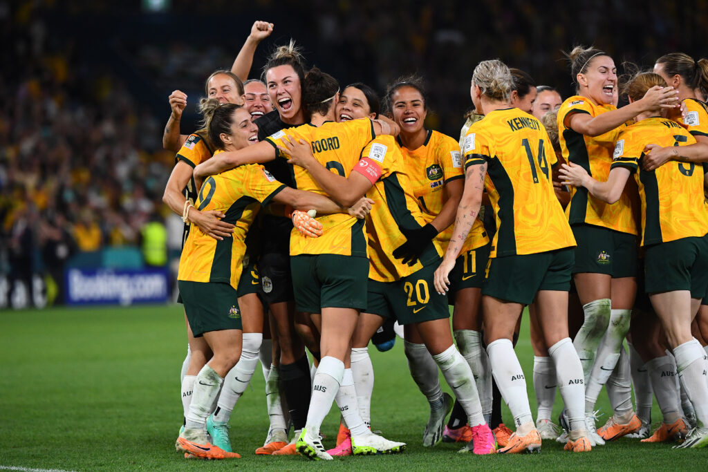 Katrina Gorry, Mackenzie Arnold and Sam Kerr of Australia celebrate with others after winning the FIFA Women's World Cup 2023 Quarter Final soccer match between Australia and France in August 2023. 