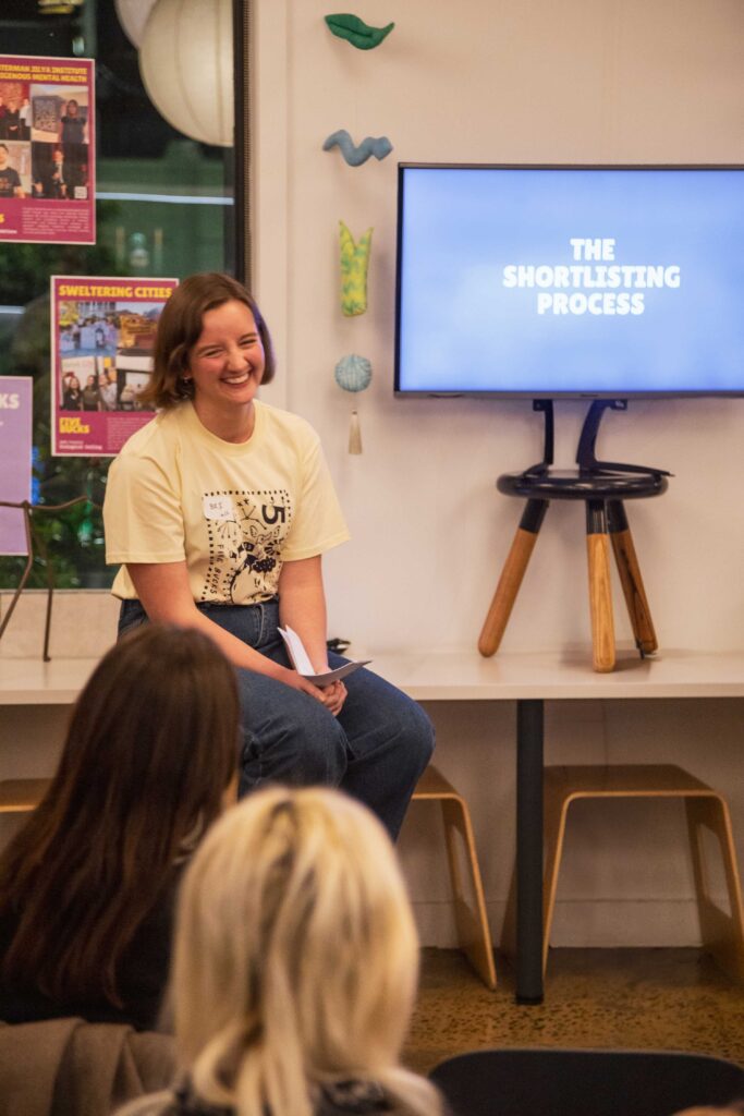 Brianna Kerr, Founder of Five Bucks, presenting at a ‘pool’ party for members
