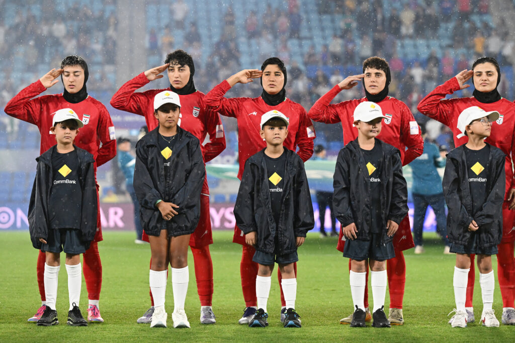 Iran players react during their national anthem ahead of the Women's Asian Cup soccer match between Iran and the Philippines in Robina, Australia, Sunday, March 8, 2026. 